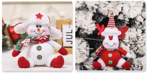 Close-up of plush snowman and reindeer Christmas ornaments with knitted hats and scarves