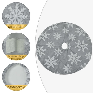 Detail view of plush grey Christmas tree skirt with white snowflake patterns and fasteners
