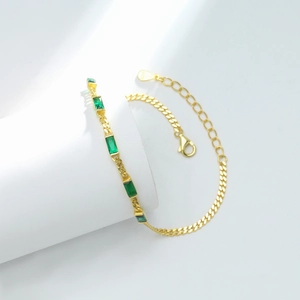 Close-up of S925 sterling silver gold bracelet with rectangular green emerald stones