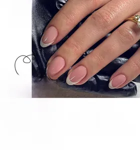 Detailed view of French tip almond press-on nails with natural pink base and white edges