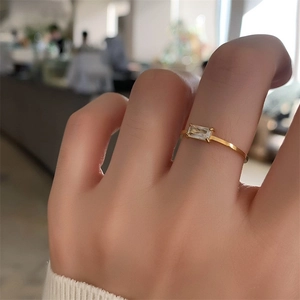 18K gold plated stainless steel ring with a rectangular clear crystal on a hand