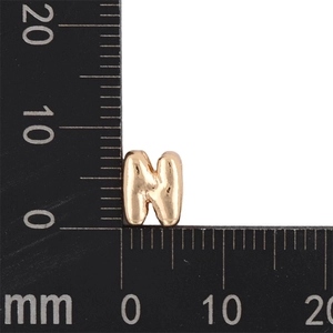 Gold KC letter N bubble pendant detail showing 9mm x 7mm dimensions on a scale