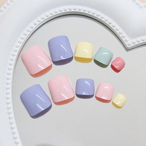 Colorful macaron press-on toenails set displayed on a vintage mirror frame