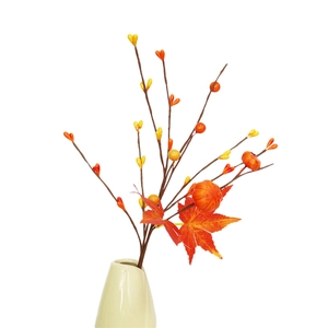 Artificial autumn stem with maple leaves and mini pumpkins in a ceramic vase