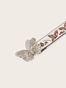 Detail of silver butterfly buckle on white Y2K belt with heart and butterfly print