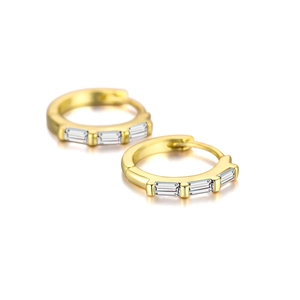 Macro detail of gold-plated S925 silver hoop earrings with rectangular cubic zirconia stones