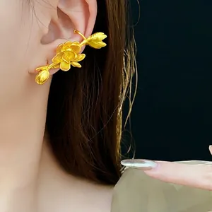 Elegant gold lotus ear cuff with matte finish and delicate floral petal carving texture
