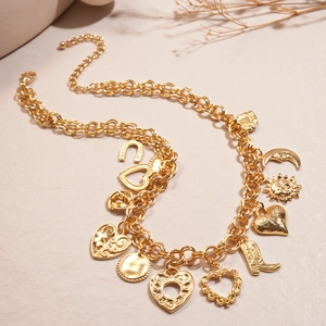 Detailed close-up of gold chunky chain necklace with heart, moon, and boot charms