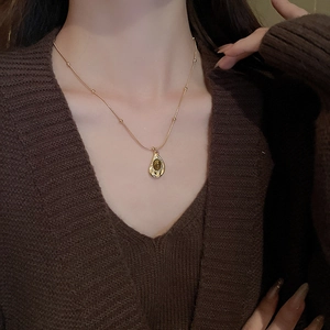 Close-up of vintage golden tiger eye stone teardrop necklace on model neck