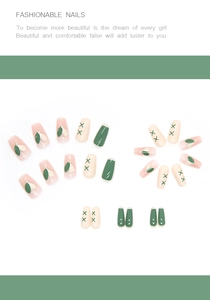 Detail of ballerina press-on nails featuring green and pink floral leaf patterns