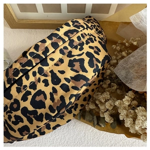 Close-up of leopard print canvas waist bag for kids with detailed fabric texture