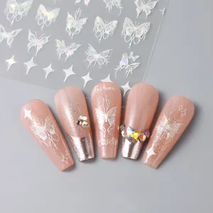 Detail of 3D laser silver butterfly and star nail stickers on nude pink French manicure