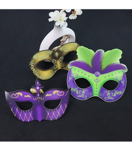 Three assorted masquerade half-face masks with glitter and feathers for party decor