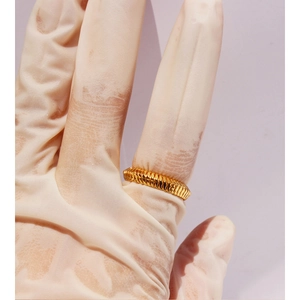 Chic gold plated snake bone spiral textured open ring for women on lilac background