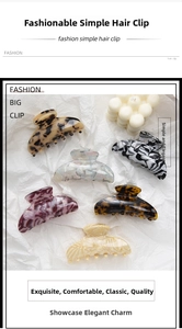 Close-up of leopard and marble pattern acetate claw clips on white textured paper