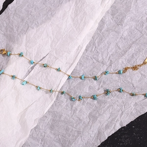 Detail of 18K gold-plated stainless steel chain with irregular blue turquoise stones