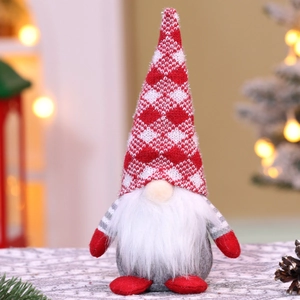 Macro detail of sitting Christmas gnome doll with red white knit hat and white plush beard