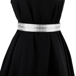 Detail of silver rhinestone wide elastic belt with geometric V-pattern over black dress