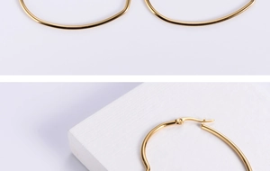 Detailed side view of golden heart-shaped hoop earrings with minimalist clasp mechanism