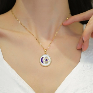 Gold titanium necklace with blue enamel moon eye pendant and sparkling crystals