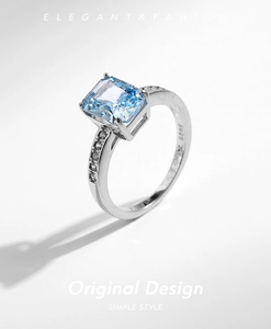 Macro detail of S925 sterling silver ring with emerald cut blue cubic zirconia