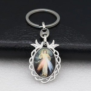 Detailed close-up of Divine Mercy Jesus religious pendant on silver metal keychain