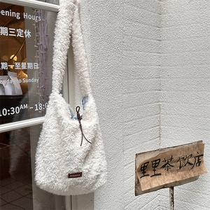 Detail of soft fleece tote bag with brown leather logo tag and drawstring lining