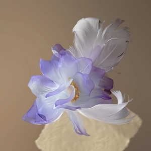 Detailed shot of purple fabric flower hair clip with soft white feathers and yellow stamen