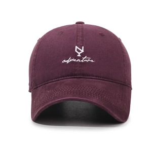 Vintage burgundy baseball cap with adventure embroidery and curved brim on white background
