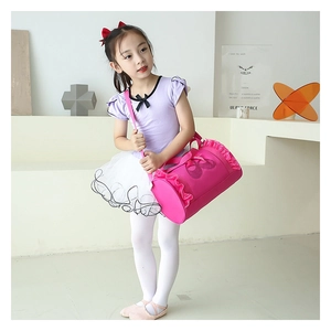 Close-up of pink barrel dance bag featuring ruffles and glittery ballet shoe design