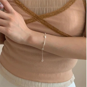 Close-up of S925 sterling silver chain bracelet with heart charms on model wrist