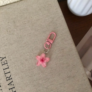 Detailed close-up of a pink resin flower keychain with matching pink metal hook and ring