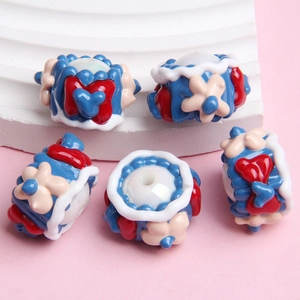 Detailed view of hand-painted cake shaped beads for DIY winter jewelry making
