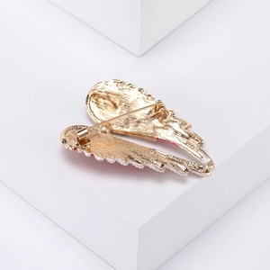 Back view of gold angel wing brooch with enamel edges and secure rotating pin clasp