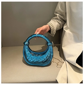 Chic metallic blue crescent handbag featuring woven texture and unique knotted handle detail