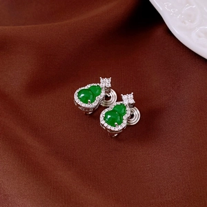 Detail of green gourd earrings with zircon inlay and silver mosquito coil ear clips