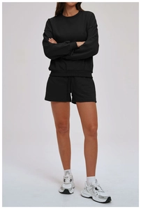 Detail of black cotton sweatshirt and drawstring shorts set for casual outdoor wear