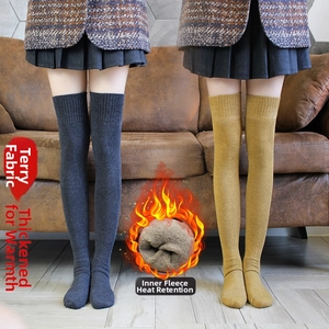 Detail showing thick thermal fleece lining inside dark grey and ginger knit over-knee socks