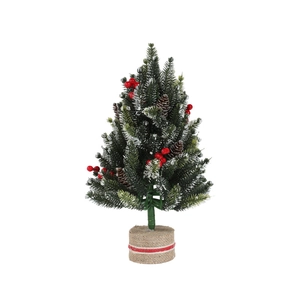 Mini snowy Christmas tree with red berries and pine cones on a rustic burlap base