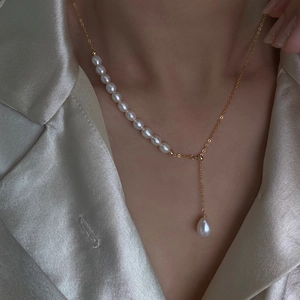 Elegant 14K gold filled natural freshwater pearl Y-necklace on a silk fabric background