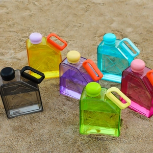 Outdoor view of multi-colored square sports water bottles in oil barrel shape on sand