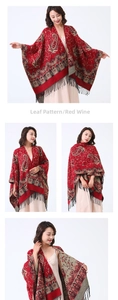 Detail of burgundy pashmina shawl with vintage paisley patterns and long black tassels
