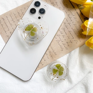 Detail of heart and round phone grips with clover and gold foil on vintage paper