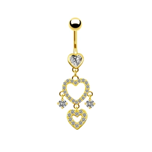 Macro detail of gold belly ring featuring heart pendants and sparkling clear diamonds