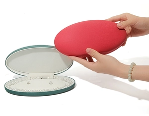Close-up of pearl necklace and earrings inside an oval velvet jewelry gift box