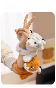 Detail of cute plush tiger slap bracelets in white and orange on a person's wrist