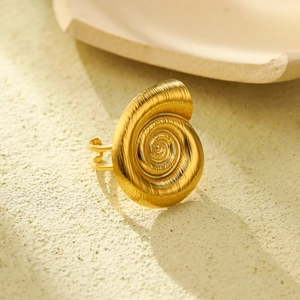 Golden stainless steel seashell ring with double band on stone surface