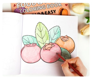 Close-up of food and fruit coloring book showing bold line drawings for kids