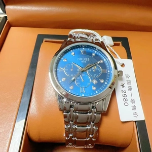 Close-up of a premium blue dial quartz watch with steel band and luminous diamond markers