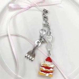 Handmade strawberry cake pendant with metal fork charm on a beaded phone strap
